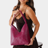 Orchid Large | Model holding mid-size shoulder bag with magnetic snap closure