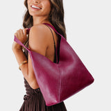 Orchid Large | Model wearing mid-size shoulder bag with magnetic snap closure