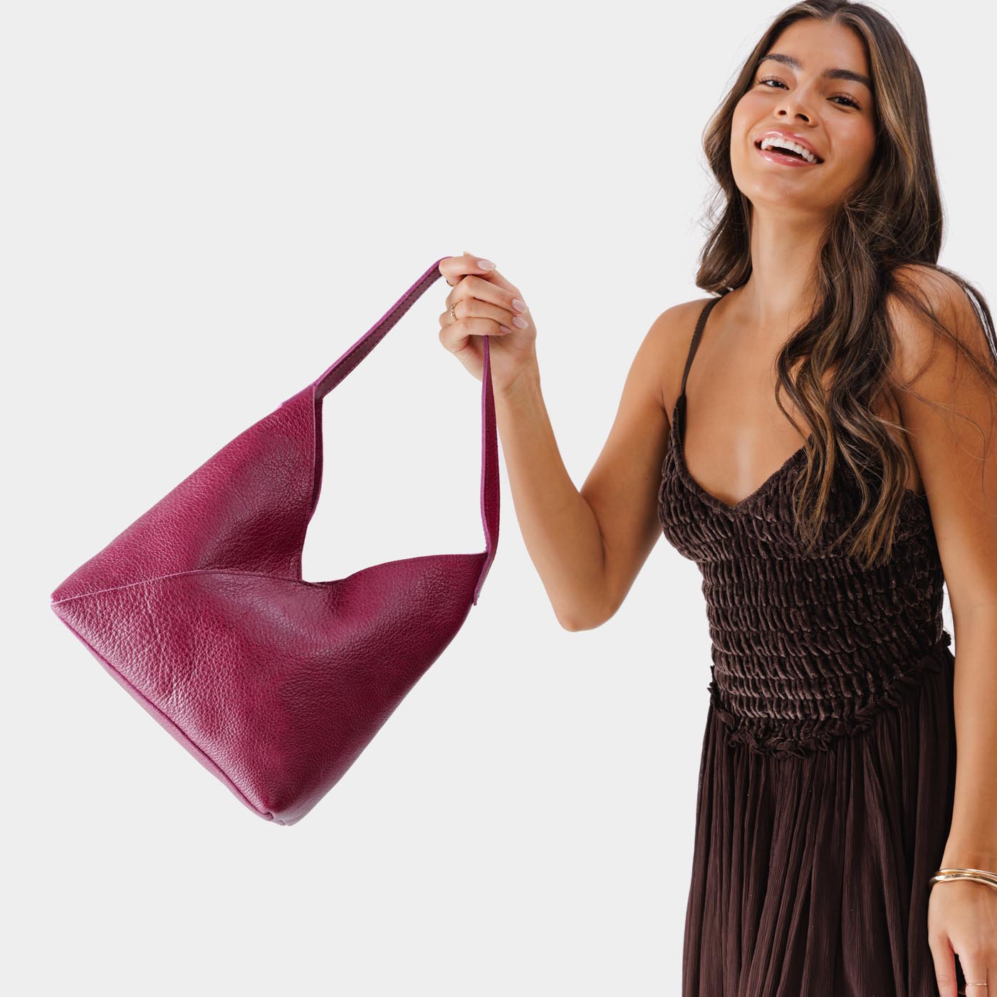 Lrg Naomi Shoulder Bag Mystery | Model holding handbag with cross bag stitching detail