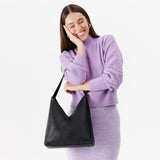 Pebbled--black Large | Model wearing mid-size shoulder bag with magnetic snap closure