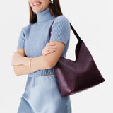 Plum Large | Model wearing mid-size shoulder bag with magnetic snap 