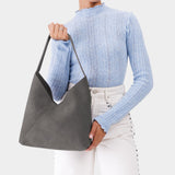 Smoke Grey Large | Model wearing mid-size shoulder bag with magnetic snap closure