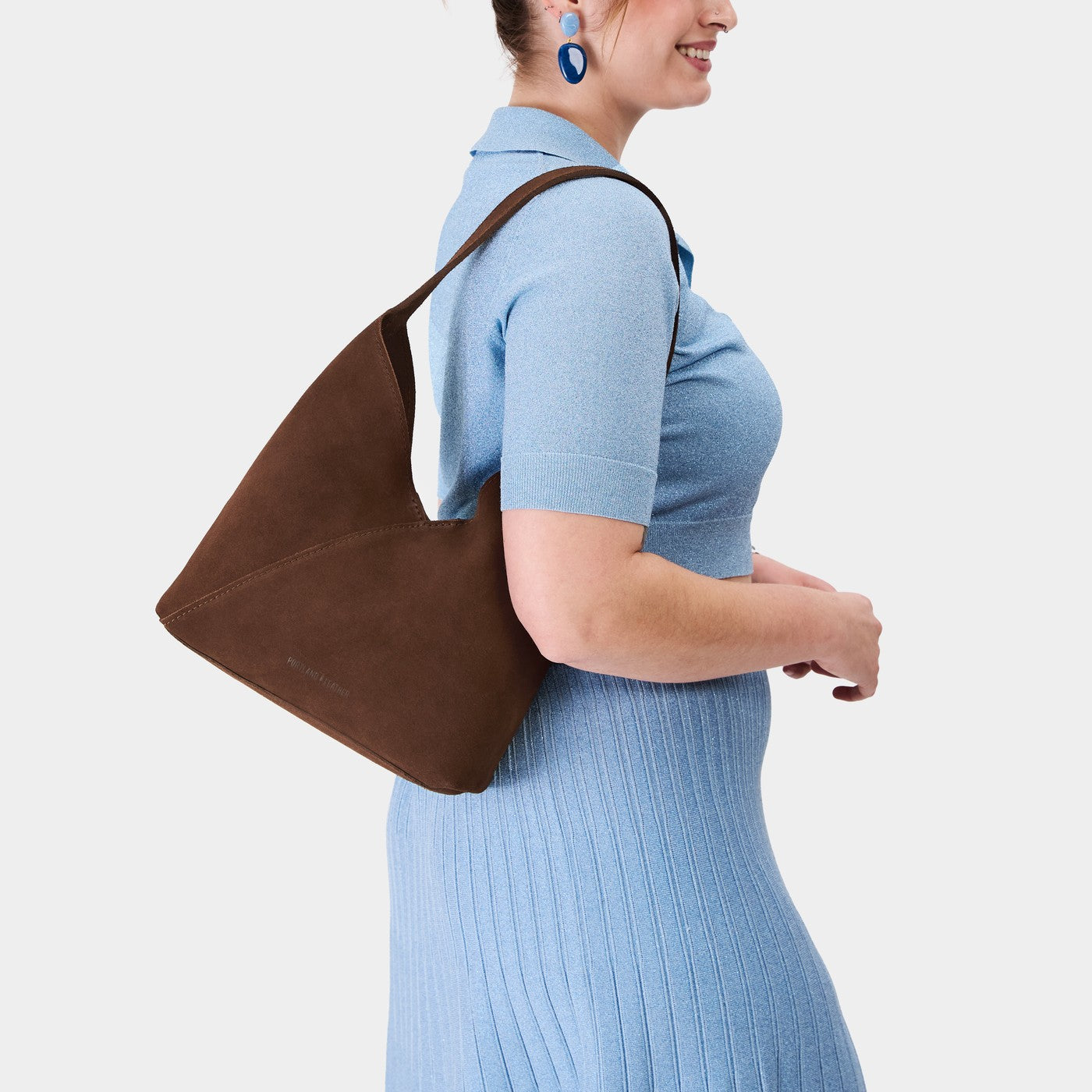 Stagecoach*Large | Model wearing mid-size shoulder bag with magnetic snap closure