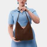 Stagecoach Large | Model wearing mid-size shoulder bag with magnetic snap closure