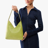 Wasabi Large | Model wearing mid-size shoulder bag with magnetic snap 