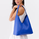 Astro Blue Oversized | Model wearing large shoulder bag with magnetic snap closure