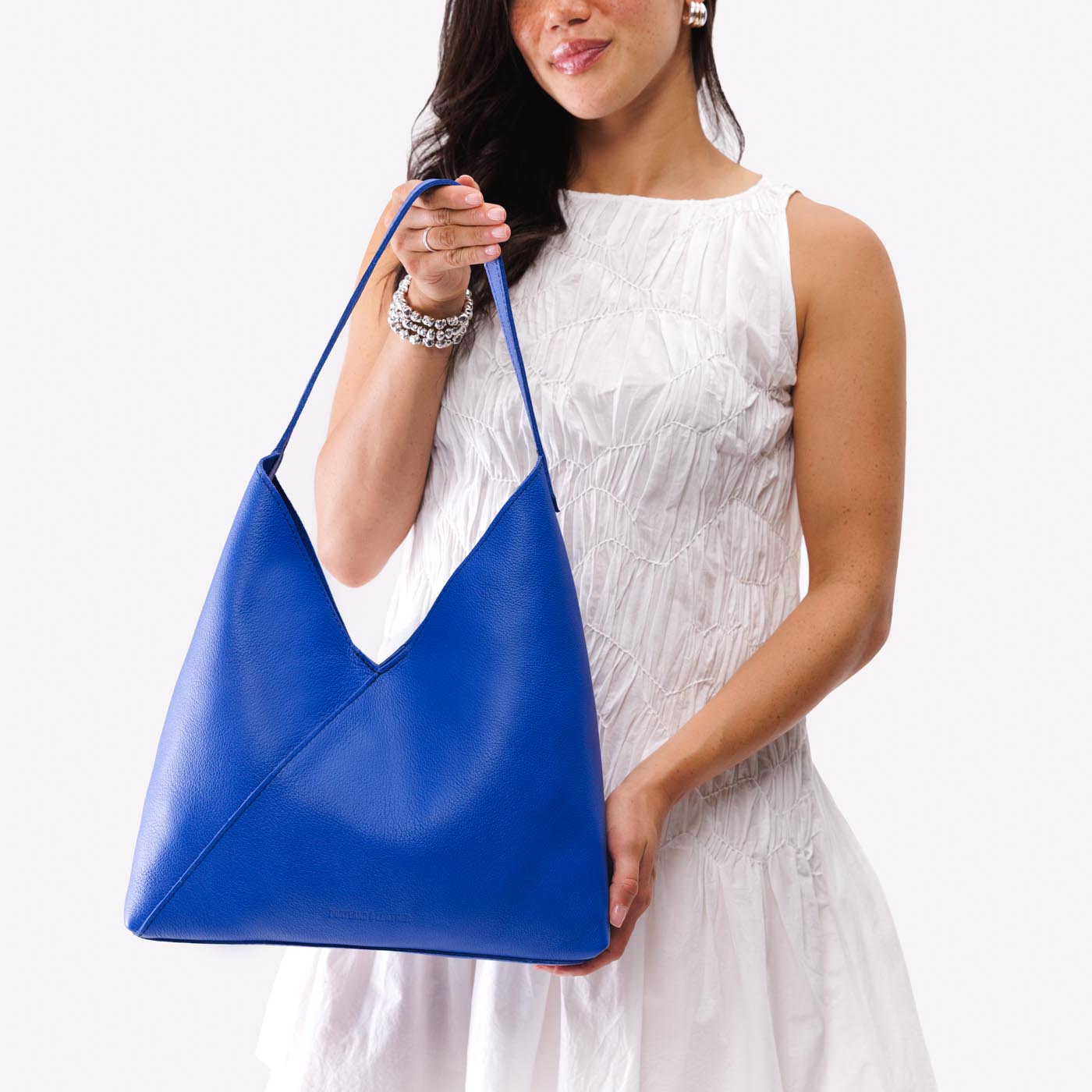 Astro Blue*Oversized | Model wearing large shoulder bag with magnetic snap closure