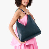 Boreal Oversized | Model wearing large shoulder bag with adjustable strap and magnetic snap closure