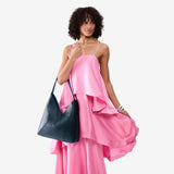 Boreal Oversized | Model wearing large shoulder bag with adjustable strap and magnetic snap closure