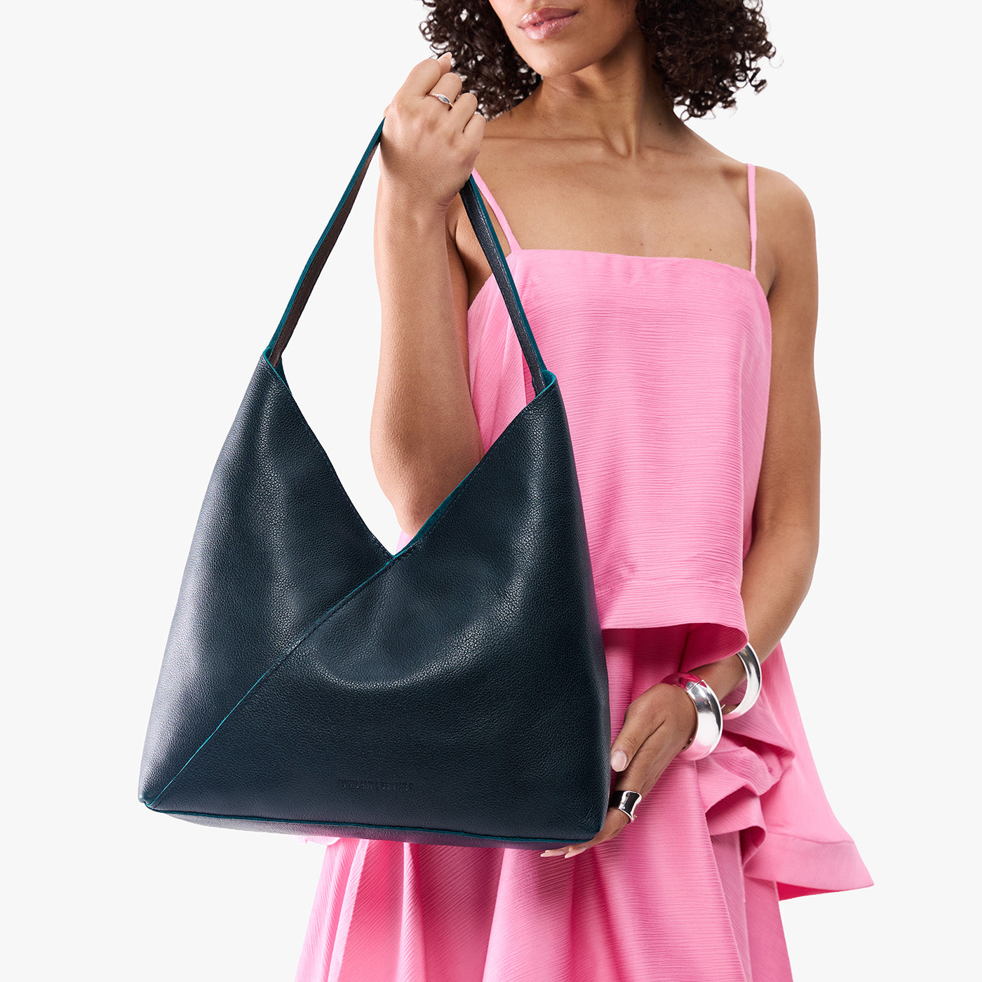 Boreal*Oversized | Model wearing large shoulder bag with adjustable strap and magnetic snap closure
