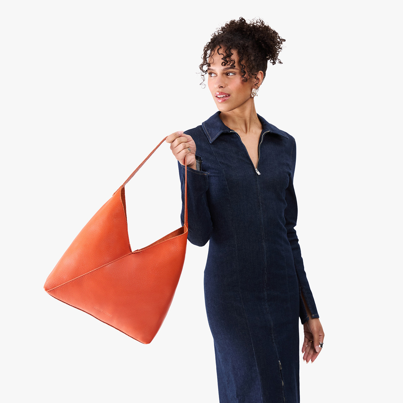 Koi*Oversized | Model wearing large shoulder bag with adjustable strap and magnetic snap closure