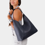 Night Owl Oversized | Model wearing large shoulder bag with adjustable strap and magnetic snap closure