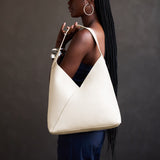 Pebbled Bone Oversized | Model carrying a large shoulder bag with magnetic snap closure