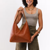 Sienna Oversized | Model holding large shoulder bag with magnetic snap closure