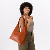 Sienna Oversized | Model holding large shoulder bag with magnetic snap closure