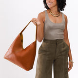 Sienna Oversized | Model holding large shoulder bag with magnetic snap closure
