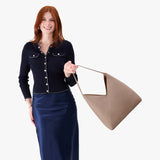 Stone Oversized | Model wearing large shoulder bag with adjustable strap and magnetic snap closure