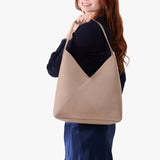 Stone Oversized | Model wearing large shoulder bag with adjustable strap and magnetic snap closure