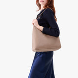 Stone Oversized | Model wearing large shoulder bag with adjustable strap and magnetic snap closure