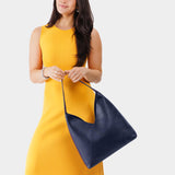 Cobalt Oversized | Model wearing large shoulder bag with magnetic snap closure