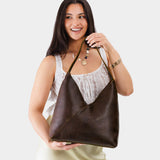 OS Naomi Shoulder Bag Mystery | Model holding handbag with cross bag stitching detail