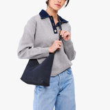 Alaska Blue Small | Model wearing petite shoulder bag with adjustable strap and magnetic snap closure
