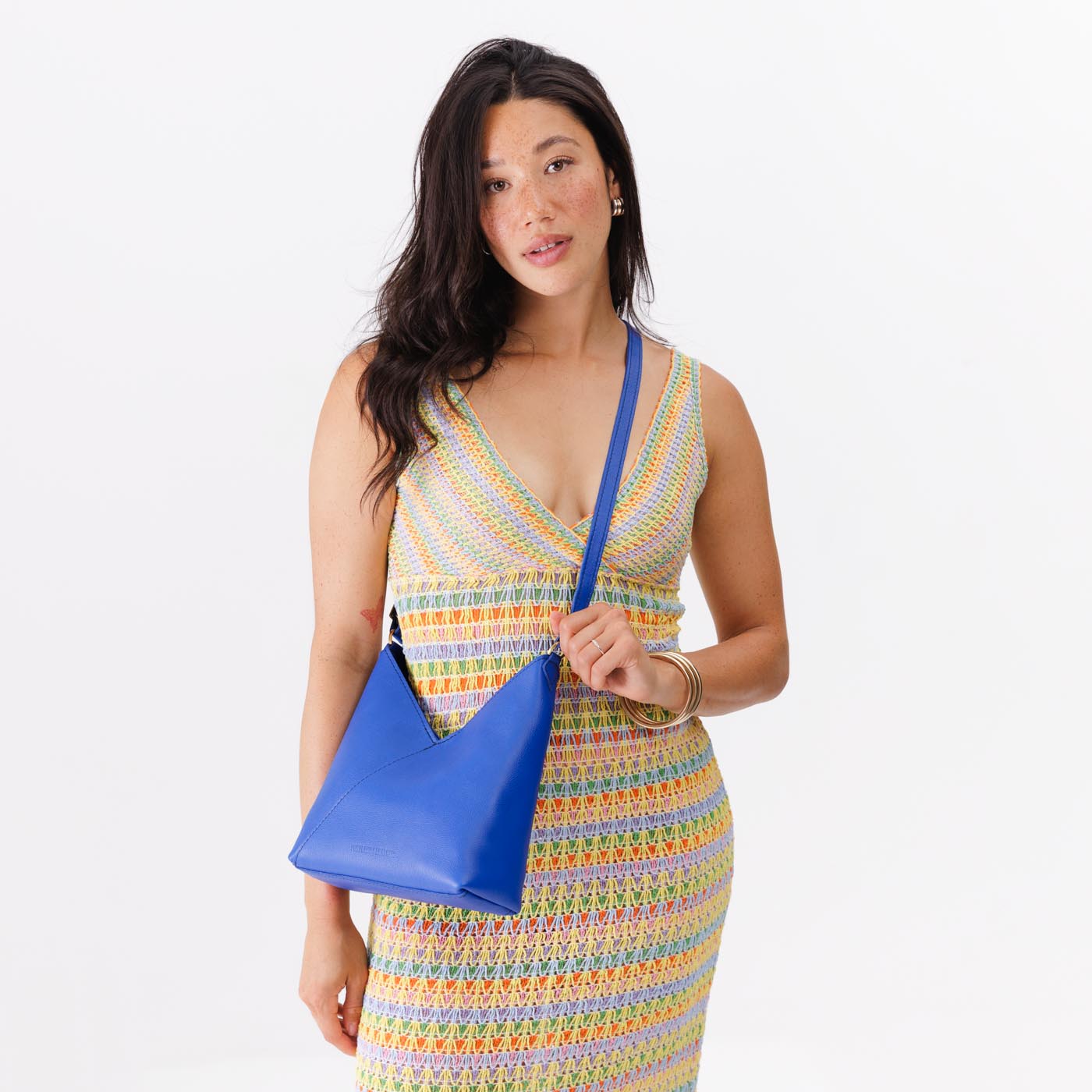 Astro Blue*Small | Model wearing petite shoulder bag with adjustable strap and magnetic snap closure