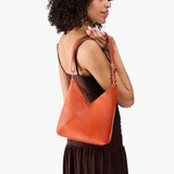 Koi Small | Model wearing petite shoulder bag with adjustable strap and magnetic snap closure
