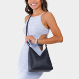 Night Owl Small | Model wearing petite shoulder bag with adjustable strap and magnetic snap closure
