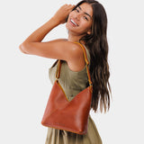 Sienna Small | Model wearing petite shoulder bag with adjustable strap and magnetic snap closure