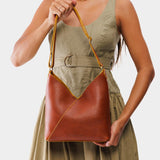 Sienna Small | Model holding petite shoulder bag with adjustable strap and magnetic snap closure