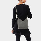 Smoke Grey Small | Model wearing petite shoulder bag with adjustable strap and magnetic snap closure