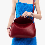Chili Red Medium | Model wearing a leather Crossbody with a flap and magnetic closure