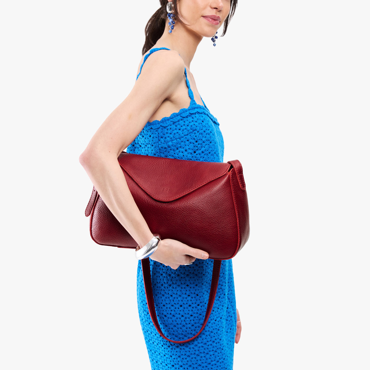 Chili Red*Medium | Model wearing a leather Crossbody with a flap and magnetic closure