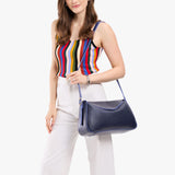 Cobalt Medium | Model wearing a leather Crossbody with a flap and magnetic closure