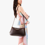 Coldbrew Medium | Model wearing a leather Crossbody with a flap and magnetic closure