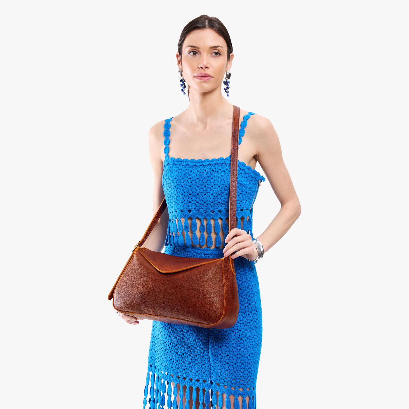 Nutmeg*Medium | Model wearing a leather Crossbody with a flap and magnetic closure
