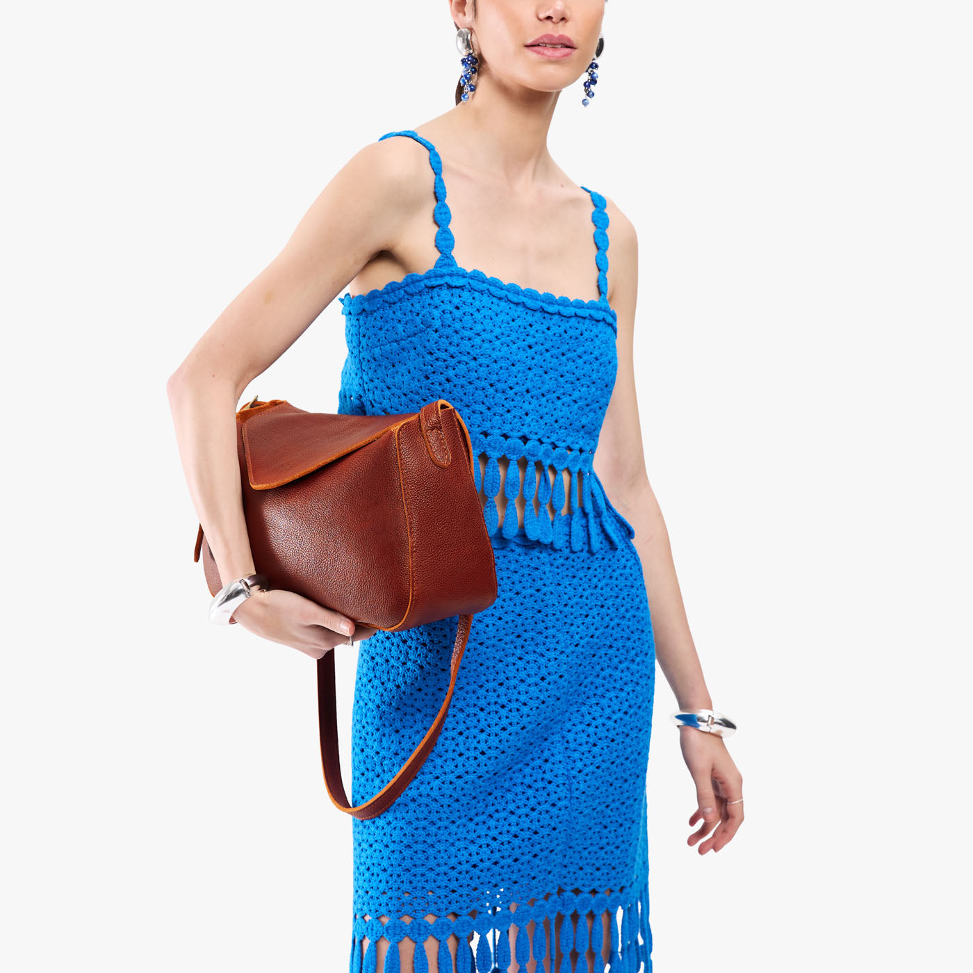 Nutmeg*Medium | Model wearing a leather Crossbody with a flap and magnetic closure