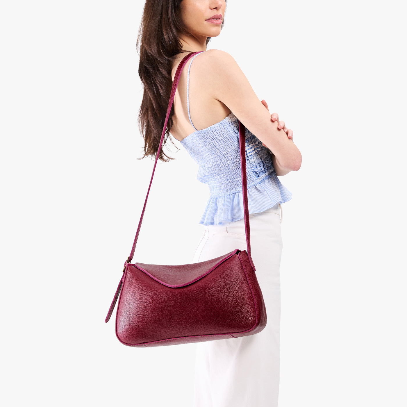 Orchid*Medium | Model wearing a leather Crossbody with a flap and magnetic closure