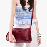 Orchid Medium | Model wearing a leather Crossbody with a flap and magnetic closure