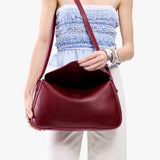 Orchid Medium | Model wearing a leather Crossbody with a flap and magnetic closure