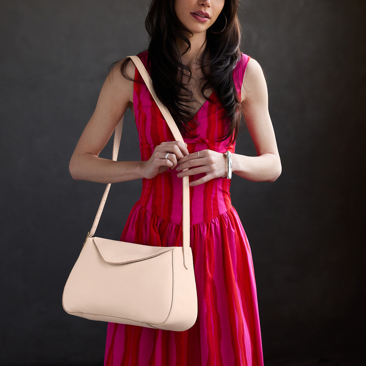 Pebbled Bone*Medium | Model wearing a leather Crossbody with a flap and magnetic closure