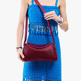 Orchid Small | Model wearing a leather Crossbody with a flap and magnetic closure