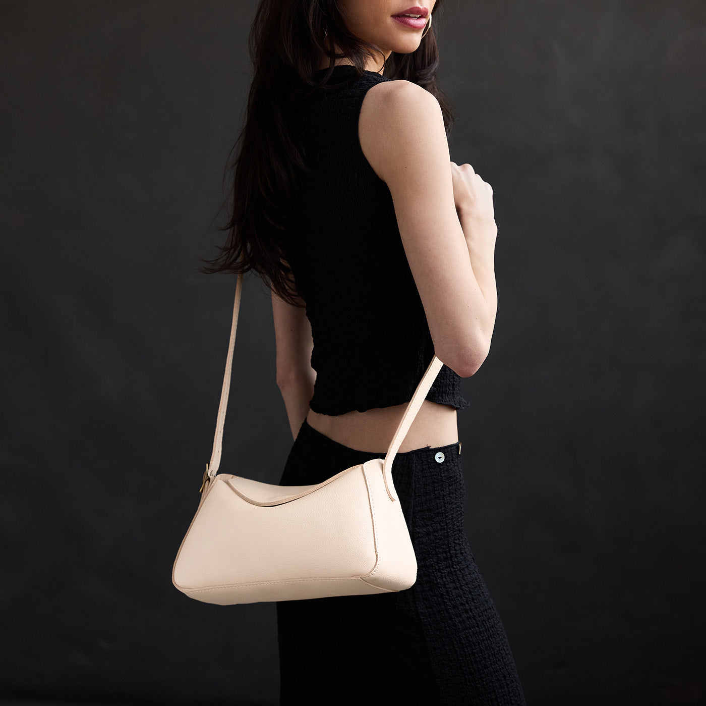 Pebbled Bone*Small | Model wearing a leather Crossbody with a flap and magnetic closure