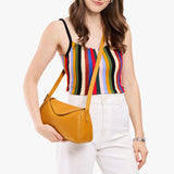 Sunshine Small | Model wearing a leather Crossbody with a flap and magnetic closure