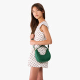 Bacalar | Model with a crescent shaped shoulder bag with zipper closure and gold accents
