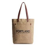 Beige tote bag with leather handles and 'Portland Leather Goods' text