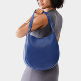 Molino Blue Large | Woman wearing rounded shoulder bag with adjustable strap on a white background