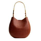 Nutmeg Large | Rounded shoulder bag with adjustable strap on a white background