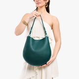 Sea Glass Large | Model holding round leather purse with adjustable shoulder strap